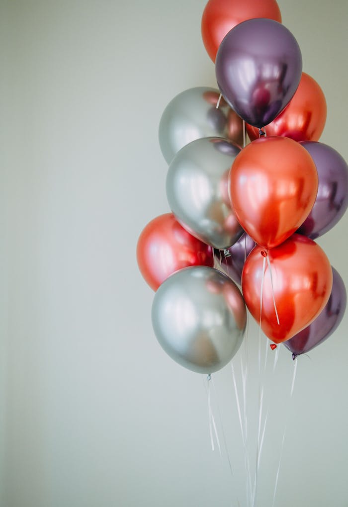 Vibrant group of red and silver balloons providing festive copyspace.